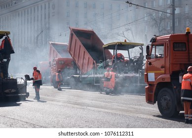 Heavy Asphalt Paver Red Truck And Road Vibrating Roller Seal Ready For Repair Roads In A Modern City