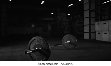 Heavy barbell on the floor of a gym studio copyspace bodybuilding weightlifting fitness power strength endurance agility workout exercising interior space crossfit box studio sportive lifestyle