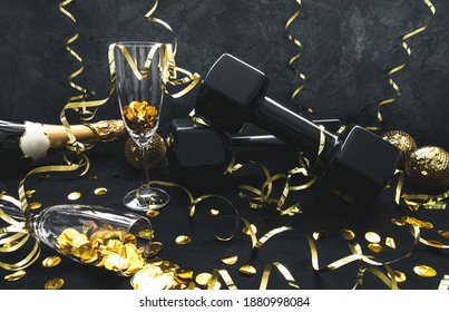 Heavy black dumbbells, champagne bottle, glasses with confetti, golden decorations for New Year's Eve celebration party. Healthy fitness lifestyle composition. Gym, workout New Year's resolution. - Powered by Shutterstock
