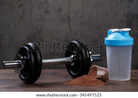 Heavy black dumbell and protein powder