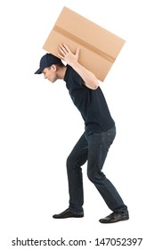 Heavy box. Side view of young deliveryman carrying a big cardboard box while isolated on white