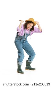 Heavy Burden. Funny Young Girl, Female Gardener In Work Uniform And Hat Shows Pantomime Isolated On White Background. Concept Of Job, Emotions, Agronomy. Funny Meme Emotions. Copy Space For Ad