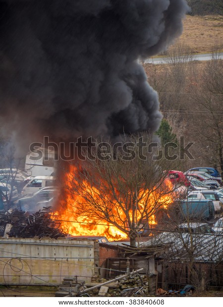 Heavy car fire blazing with black smoke after\
explosion accident