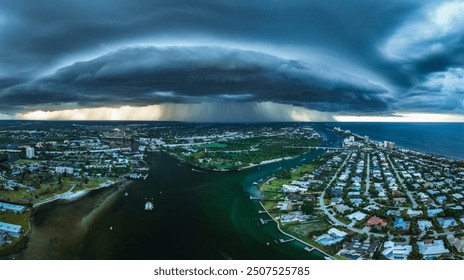 Heavy clouds of a storm front over the Loxahatchee River and the city of Jupiter in early August. Rain is visible, which pours out of the clouds on the city - Powered by Shutterstock