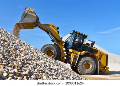 heavy construction machine in open-cast mining - wheel loader transports gravel in a gravel plant 