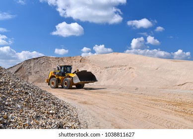 heavy construction machine in open-cast mining - wheel loader transports gravel in a gravel plant 