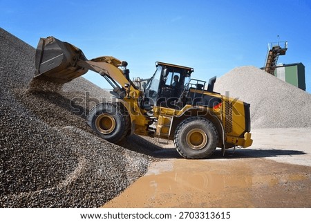 heavy construction machine in open-cast mining - wheel loader transports gravel in a gravel plant 