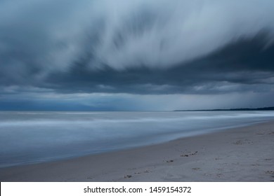 Heavy Dark Fast Moving Thunderstorm Clouds Over Lake Erie Seascape. Severe Weather, Heavy Rain, Strong Winds, Hailstorm, Hurricane Concept. Ontario, Canada. Long Exposure, HDR Image.