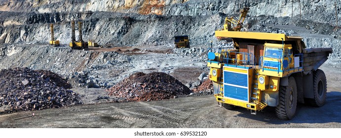Heavy dump truck carrying the iron ore on the opencast mining