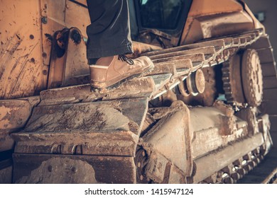 Heavy Duty Bulldozer Operator Concept Photo. Construction Equipment. Caterpillar Track Closeup.