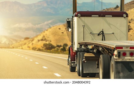 Heavy Duty Freight Theme. Semi Truck with Flatbed Trailer on a Scenic Utah Interstate 70 Highway. American Transportation Industry. - Shutterstock ID 2048004392