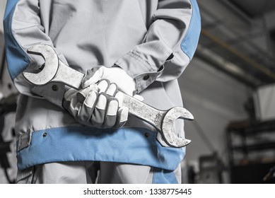 Heavy Duty Machinery Mechanic. Worker With Large Steel Wrench In Hands.