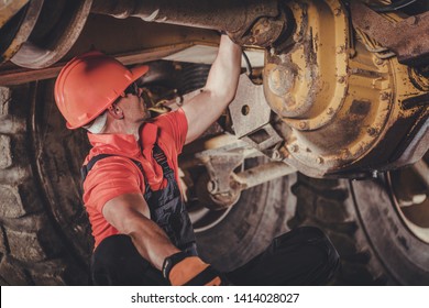 Heavy Duty Mining Dump Truck Differential Problem. Caucasian Driver Trying To Bush Fix. Heavy Duty Equipment Problem.