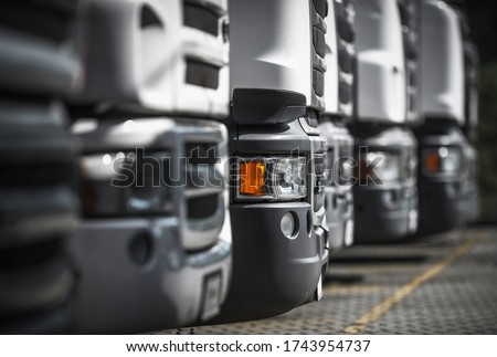Heavy Duty Transportation industry. Line of New and Pre-Owned Semi Trucks on Dealership Sales Lot.