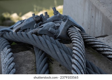 Heavy duty woven steel cables securing a barge in the Danube river.