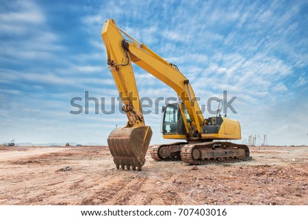 Heavy earth mover with blue sky in the background