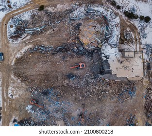 Heavy Equipment Being Used To Tear Tearing Down Building Construction. Excavator Working On A Demolition Site. Drone View 