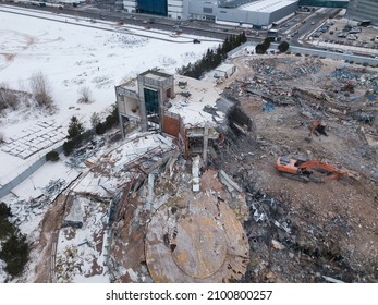 Heavy Equipment Being Used To Tear Tearing Down Building Construction. Excavator Working On A Demolition Site. Drone View 