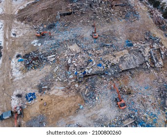 Heavy Equipment Being Used To Tear Tearing Down Building Construction. Excavator Working On A Demolition Site. Drone View 