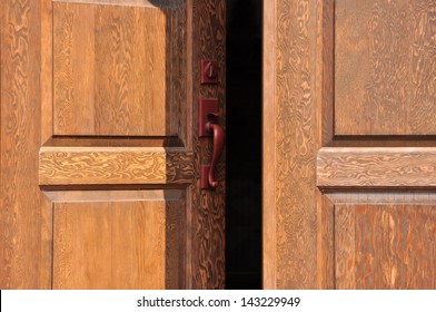 Heavy Firs Doors In The Sunlight, Slightly Open.