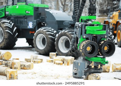 Heavy Forestry Machinery in Snow Preparing Logs for Processing - Powered by Shutterstock