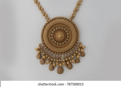 Heavy Gold Pendant On A White Background. Indian Design Motifs Used In The Jewellery.