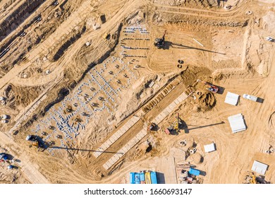 Heavy Industrial Machines Working At Construction Site. Concrete Piles For Building Foundation. Aerial Top View