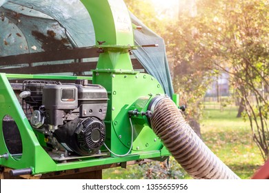 Heavy Industrial Vaccuum Loader Loading Fallen Leaves And Junk Into Truck Body. Municipal Services Cleaning Park Area Removing Foliage And Debris