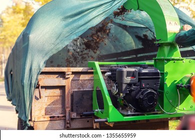 Heavy Industrial Vaccuum Loader Loading Fallen Leaves And Junk Into Truck Body. Municipal Services Cleaning Park Area Removing Foliage And Debris