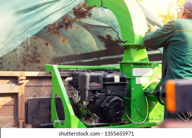 Heavy Industrial Vaccuum Loader Loading Fallen Leaves And Junk Into Truck Body. Municipal Services Cleaning Park Area Removing Foliage And Debris