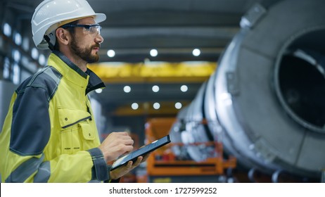 Heavy Industry Engineer In Pipe Manufacturing Factory, Use Digital Tablet Computer. Facility For Construction Of Oil, Gas And Fuel Pipeline Transportation Products. Side View