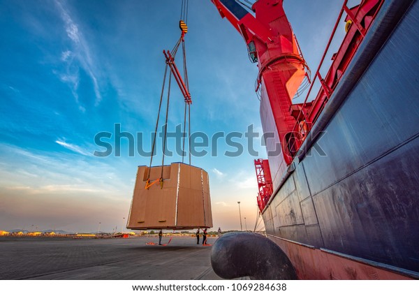 heavy lift packages cargo shipment lifting by\
the jumbo ship crane for delivery and transport to destination by\
sea and lands logistics\
services