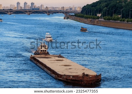 Heavy long barge sailing on the Dnieper river in Kiev, Ukraine