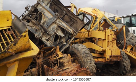 Heavy machinery scrap yard. Parts of excavators and heavy excavation vehicles that have reached the end of their useful life. Buckets, gear sets, tracks, shock absorber springs and flywheel gears. - Powered by Shutterstock