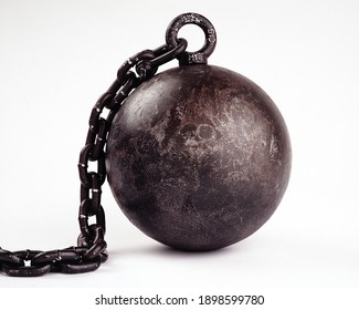 A heavy metal ball on a chain. Isolated on a white background