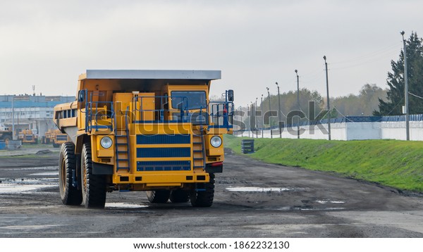 Heavy mining dump trucks are at the factory. Giant\
mining truck after being from the conveyor is tested at the factory\
test site. Heavy-duty truck manufacture by the heavy vehicle\
plant.