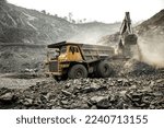 Heavy mining truck and excavator at work . Production useful minerals. Mining truck mining machinery to transport coal from open-pit production
