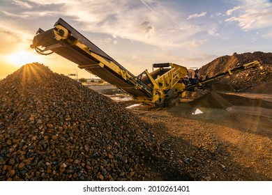 Heavy and mobile machinery in a quarry to transform stone into construction material - Shutterstock ID 2010261401
