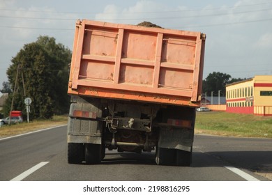 Heavy overloaded dump truck with lurch carries sand on a European countryside asphalt road at summer day - Shutterstock ID 2198816295