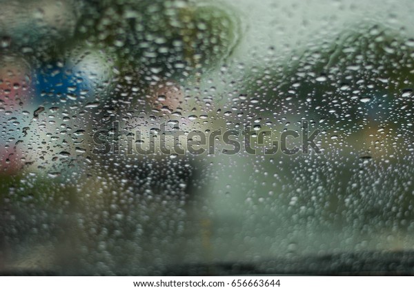 Heavy rain, blurry\
auto glass. traffic jam\
