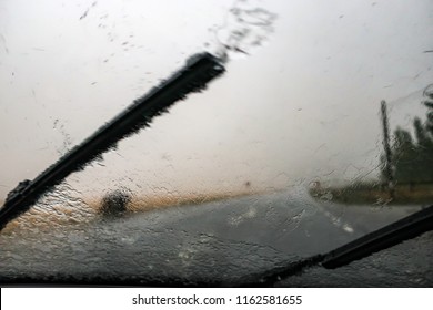 Heavy Rain. Cloudburst On Windshield. Windscreen Wiper And Bad Visibility.