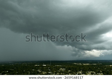 Heavy rain falling down from stormy clouds over rural Florida suburbs. Thunderstorm on dark sky. Moving and changing cloudscape weather