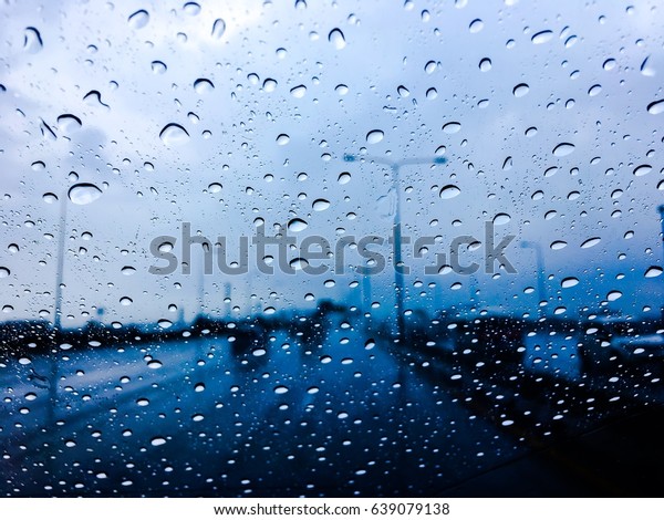 Heavy rain  on the road ,Driving must\
be slow down for safe driving, Rain clouds,Rain\
drops