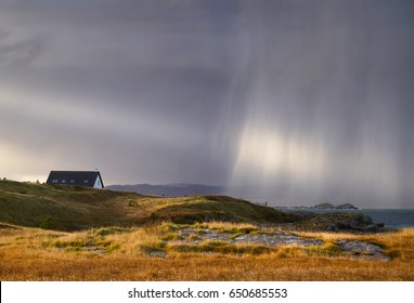 A Heavy Rain Shower Over A Croft  At Loch Ewe, Scottish Highlands, Scotland, UK.                               