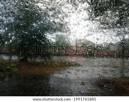 Similar – Rainy day I View through a wet window pane onto a busy street