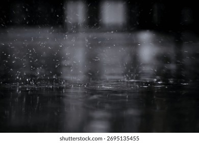 heavy raining make many small splash crown from water droplets drop down to the concrete floor in blue tone color scene 