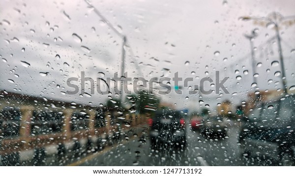 An heavy raining. The road\
are wet. To be safe, slowly and carefully on driving. Selective\
focus. 