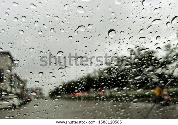 An heavy raining. The road\
are wet. To be safe, slowly and carefully on driving. Selective\
focus.