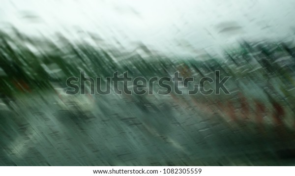 Heavy rains summer
months of April due to summer storms. Abstract blur of rain drops
falling on the
windscreen.
