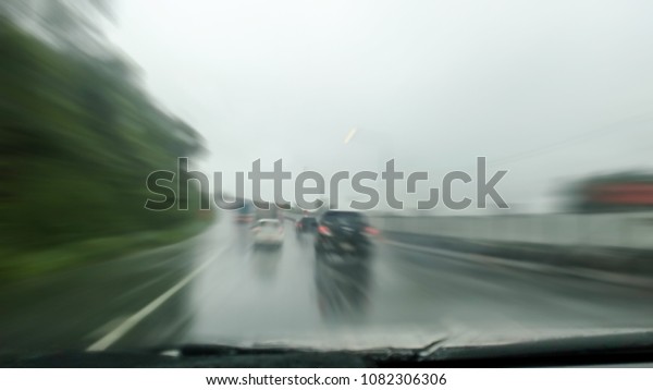 Heavy rains summer\
months of April due to summer storms. Abstract blur of rain drops\
falling on the\
windscreen.